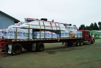 Semi Truck Loaded for delivery with packaged materials from Pan Abode Cedar Homes